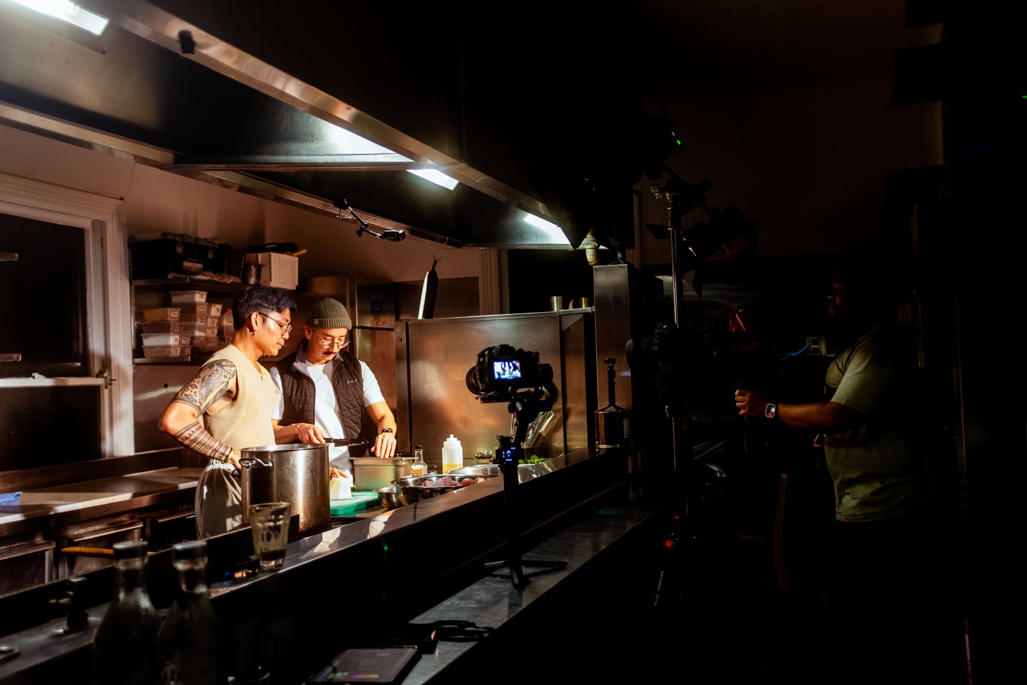 Chef Fhred and Liem cooking together during a filmed Dishes and Dialogue production